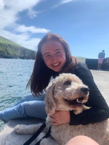 Teacher Dave female Spanish student with her dog on the harbour in Ireland