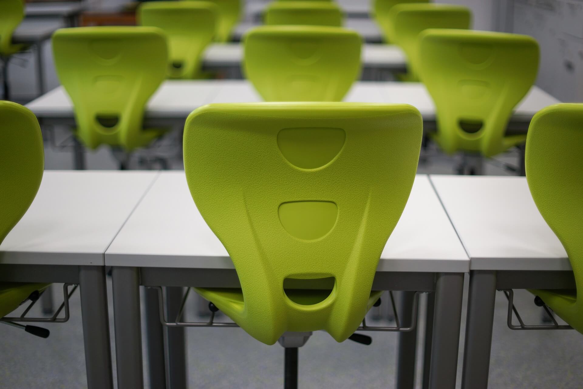 Bright green chairs in an empty classroom