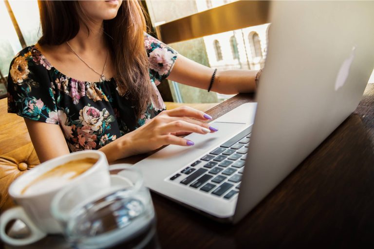 Online Spanish Grinds for Junior Cert. and Leaving Cert. students with a female student on a laptop with a coffee